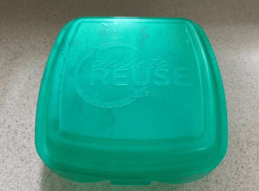 Green box from dining for students to take food to eat at convenient times.